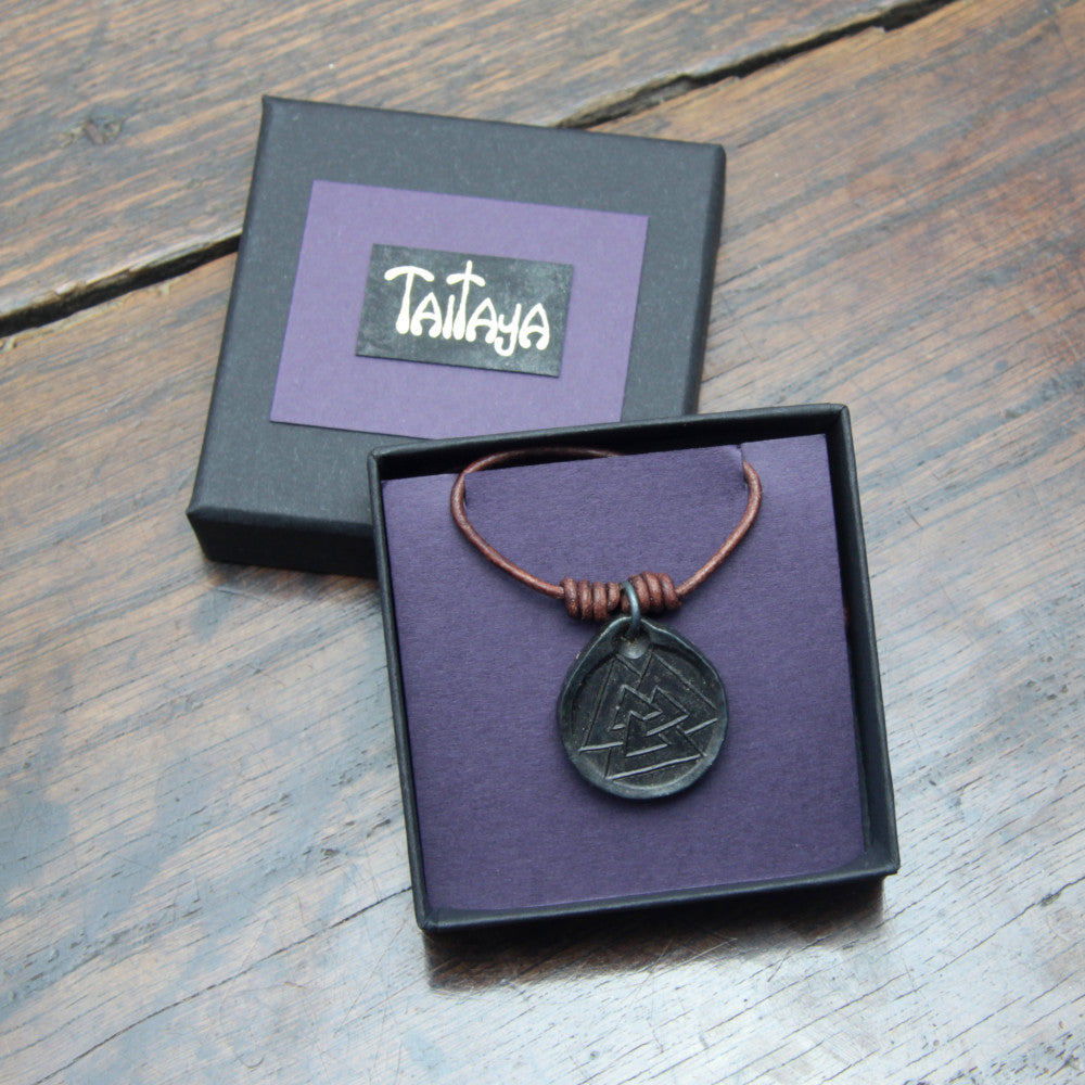 Taitay Forge Iron Valknut coin pendant with forge black finish presented in a black card gift box with gold embossed branding and purple insert