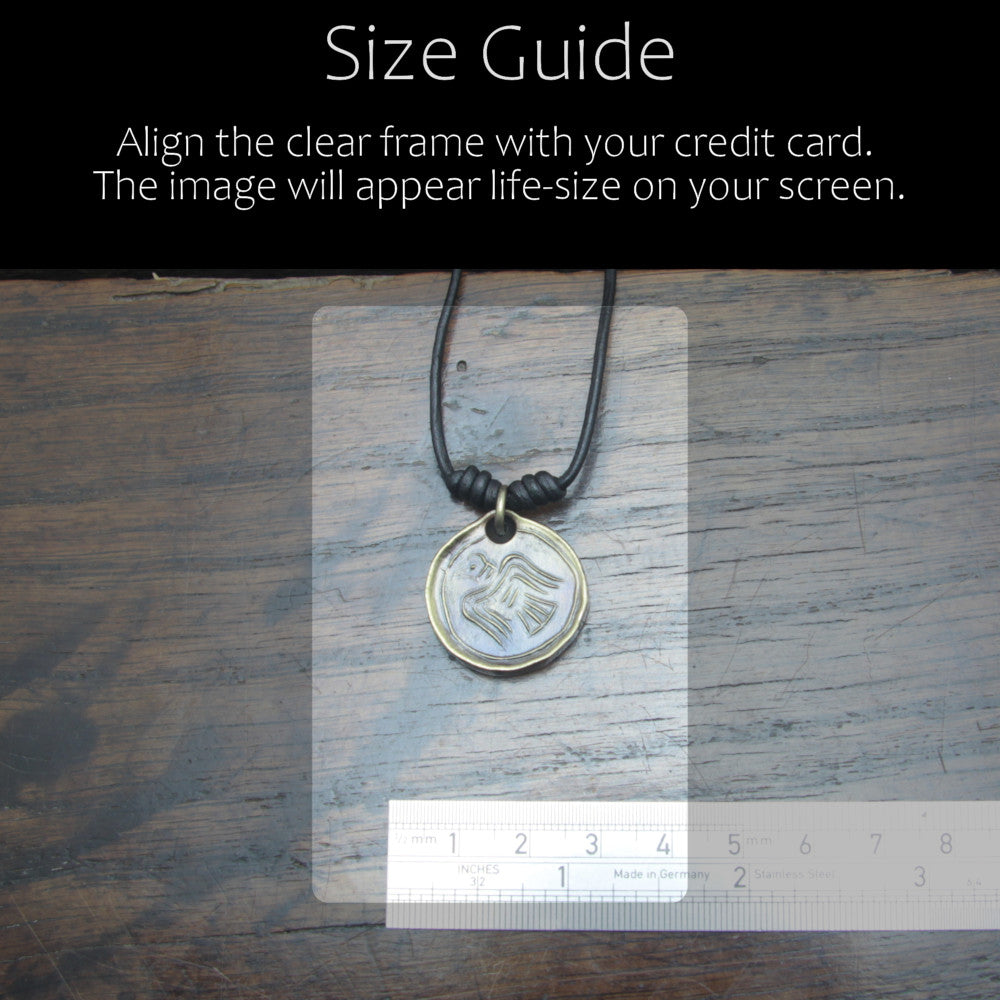 Taitay Forge Iron Norse Raven coin pendant with antique bronze finish size reference guide in camparison with a credit card or ruler