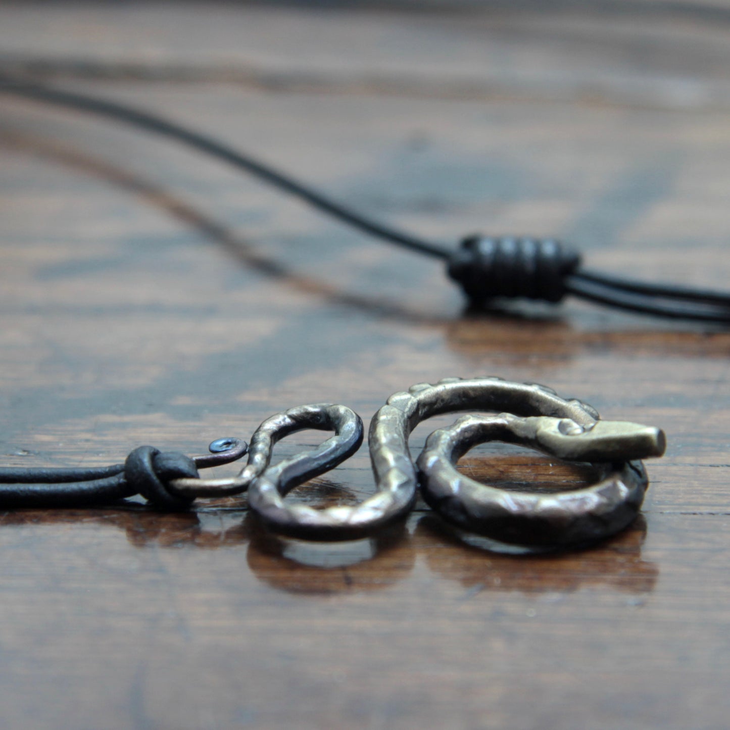 Forged iron snake pendant, side view