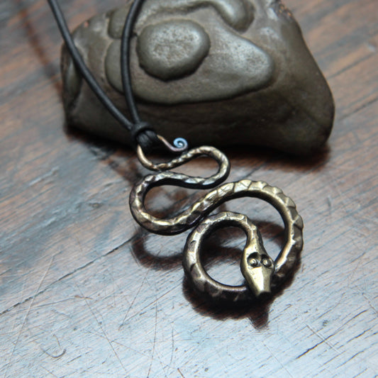 Forged iron snake pendant, with an antique bronze finish, made and designed by Taitaya Forge