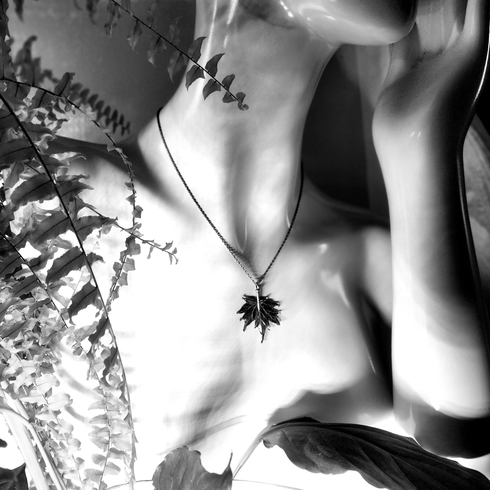 Black and white photos of the SIlver Maple Leaf necklace on a mannequin.