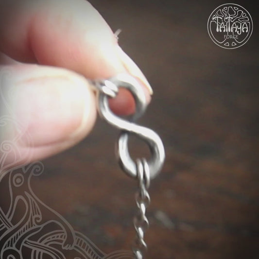 Video of the small hot forged silver infinity symbol pendant, made by Taitaya Forge.