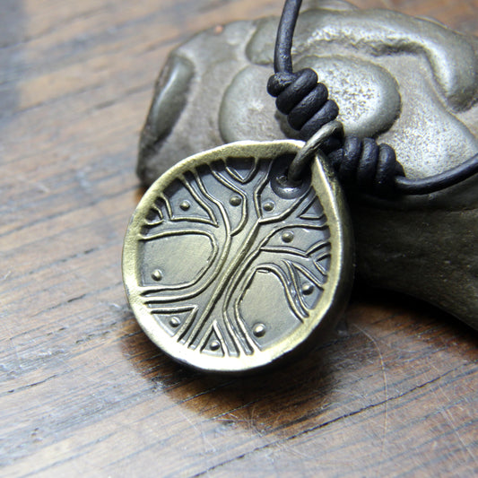 Norse Viking Yggdrasil Tree Iron Coin Pendant on a leather necklace.