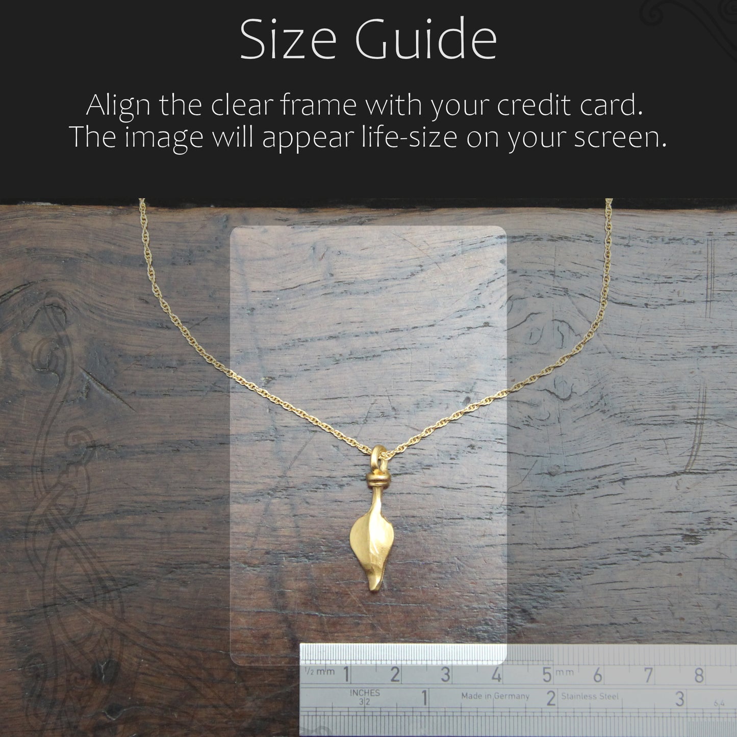 Gold necklace with a clear frame for size guide on a wooden surface