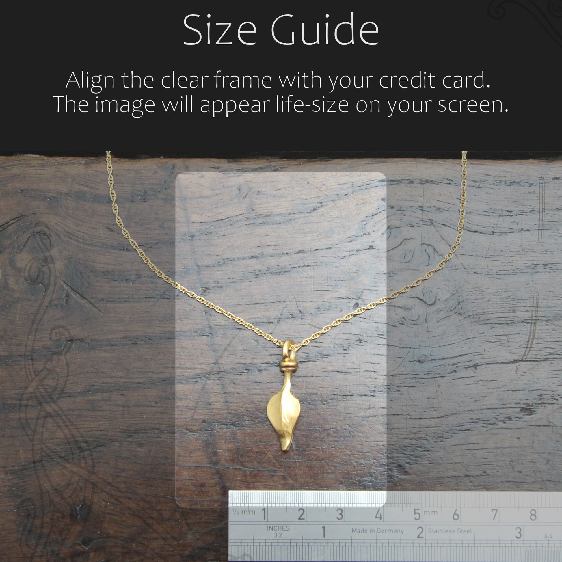 Gold necklace with a clear frame for size guide on a wooden surface