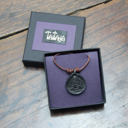 Taitay Forge Iron Valknut coin pendant with forge black finish presented in a black card gift box with gold embossed branding and purple insert