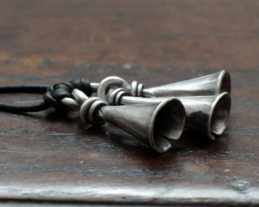 Hot Forged Sterling silver bell necklace by artist blacksmith Marleena Barran from Taitaya Forge