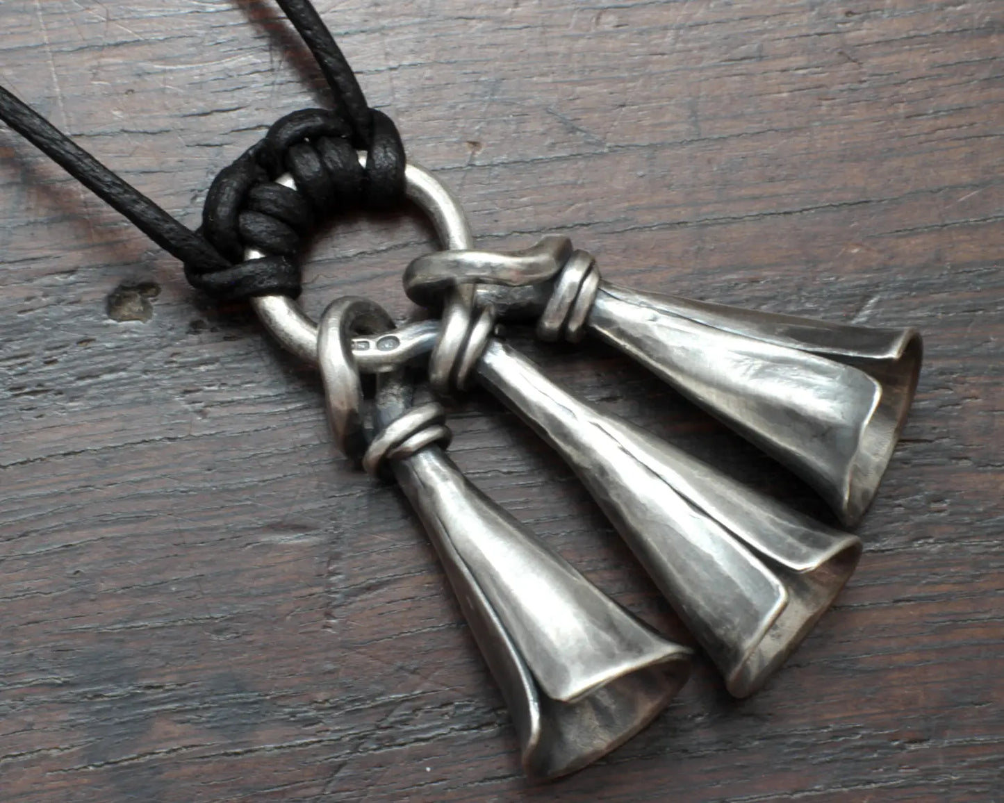 Hot Forged Sterling silver bell necklace by artist blacksmith Marleena Barran from Taitaya Forge