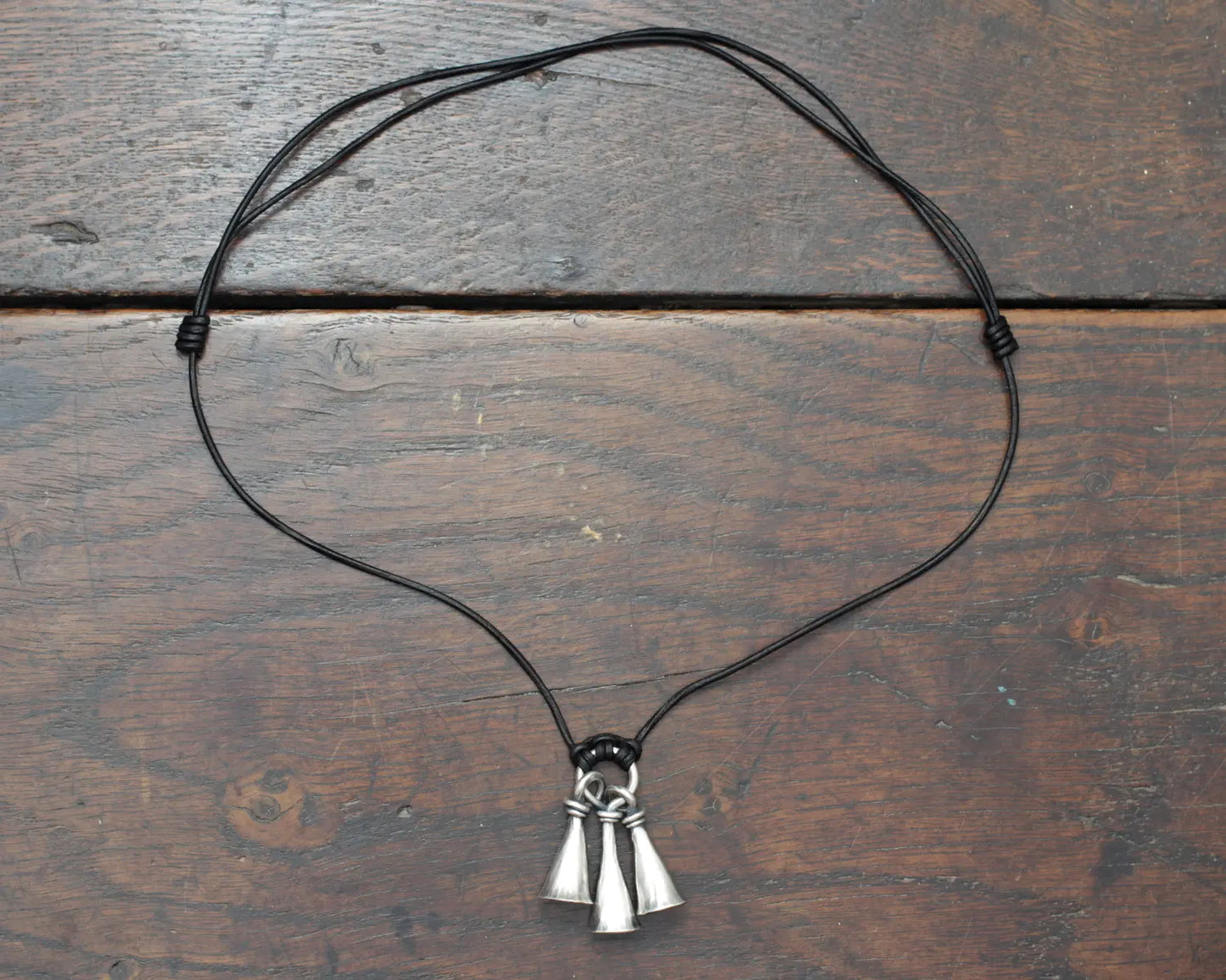 Hot Forged Sterling silver bell necklace by artist blacksmith Marleena Barran from Taitaya Forge