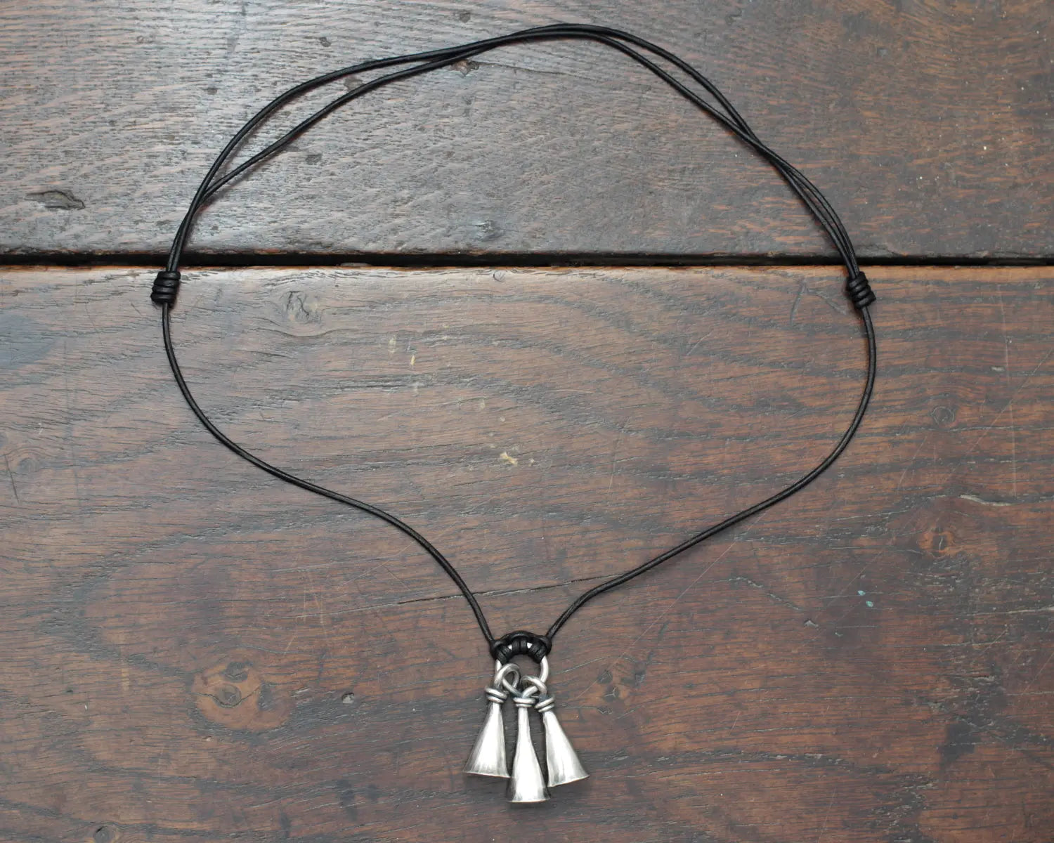 Hot Forged Sterling silver bell necklace by artist blacksmith Marleena Barran from Taitaya Forge