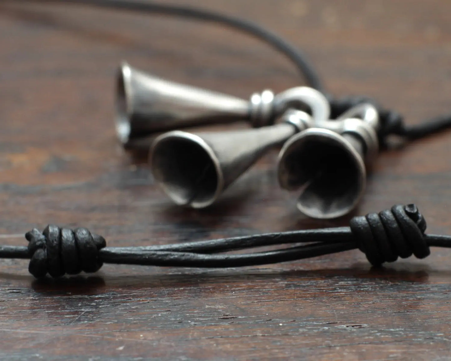 Hot Forged Sterling silver bell necklace by artist blacksmith Marleena Barran from Taitaya Forge