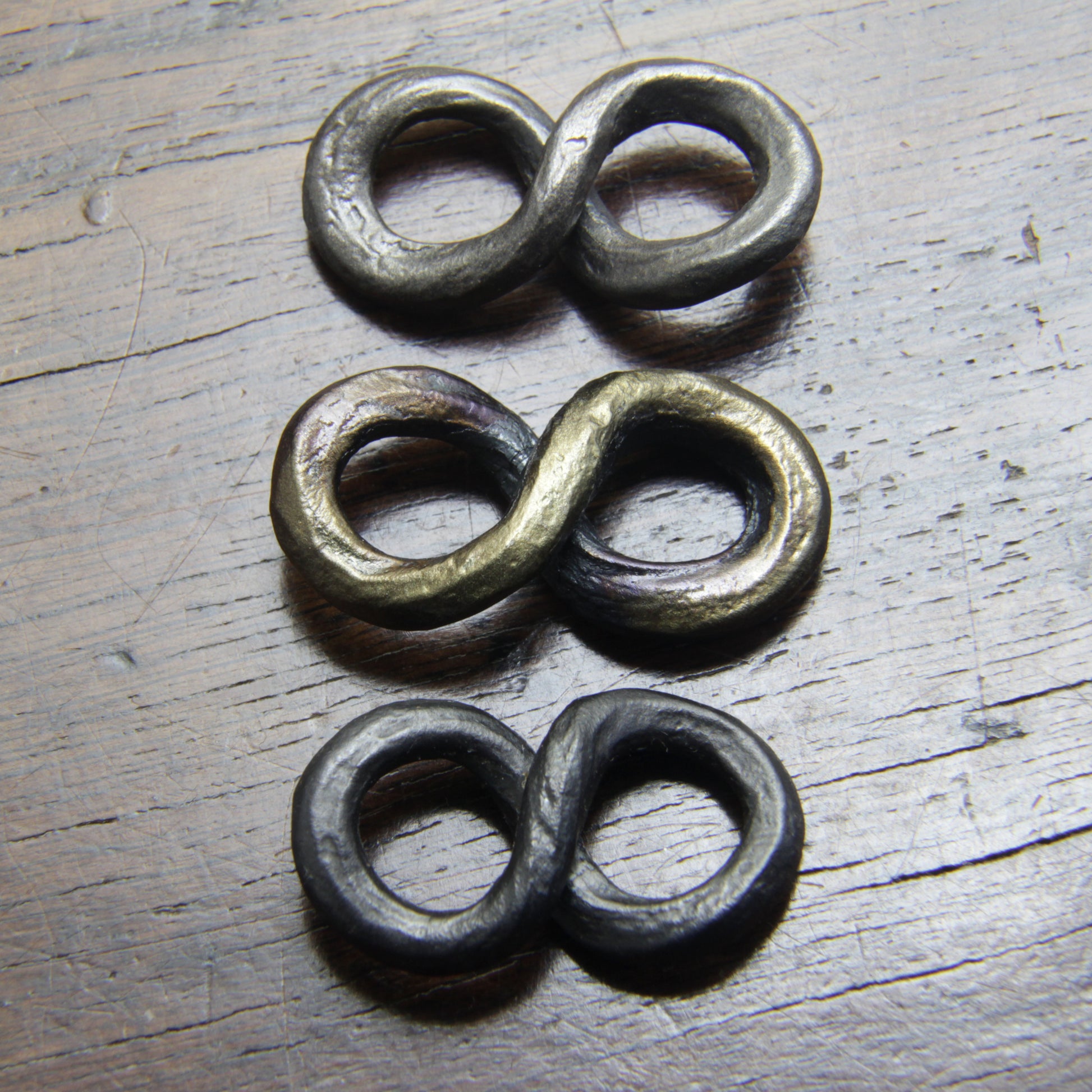 Forged Iron Infinity pendants by Taitaya Forge