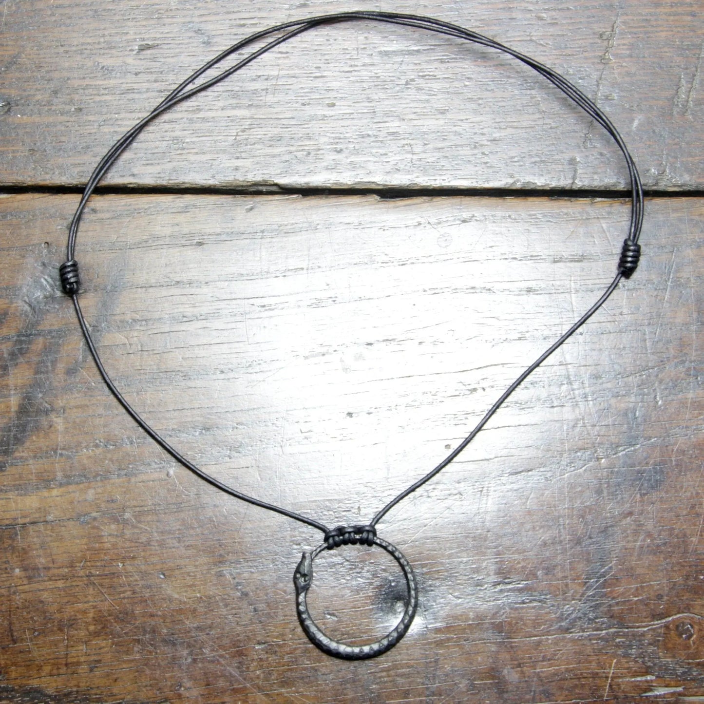 Ouroboros Snake Pendant, an infinity symbol hand forged out of pure iron
