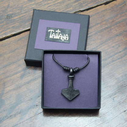 Taitay Forge iron Thor's hammer mjolnir pendant with a looped handle presented in a black gift box with gold embossed logo and a purple card insert. 