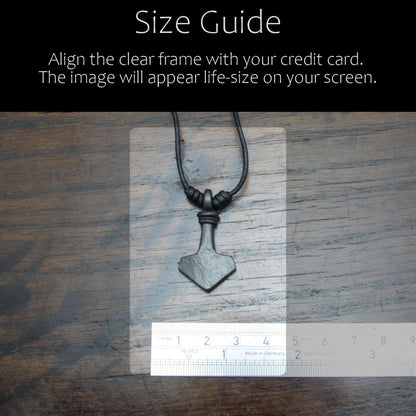 Handforged iron Mjolnir Thor's hammer pendant made by taitaya forge, size guid in comparison with a credit card and ruler