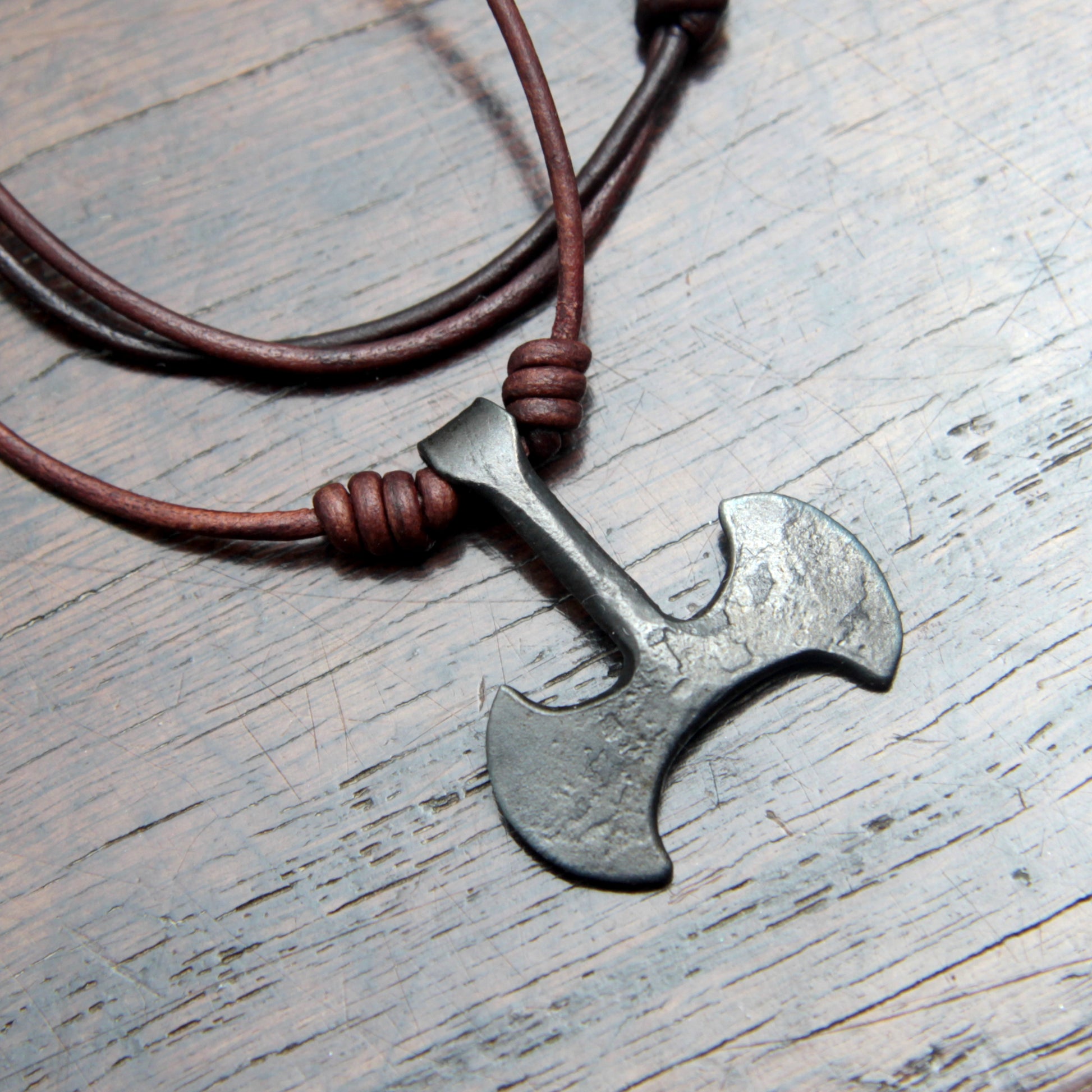Picture of the front and leather cord on the Taitaya Forge iron Labrys pendant.