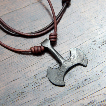 Picture of the front and leather cord on the Taitaya Forge iron Labrys pendant.