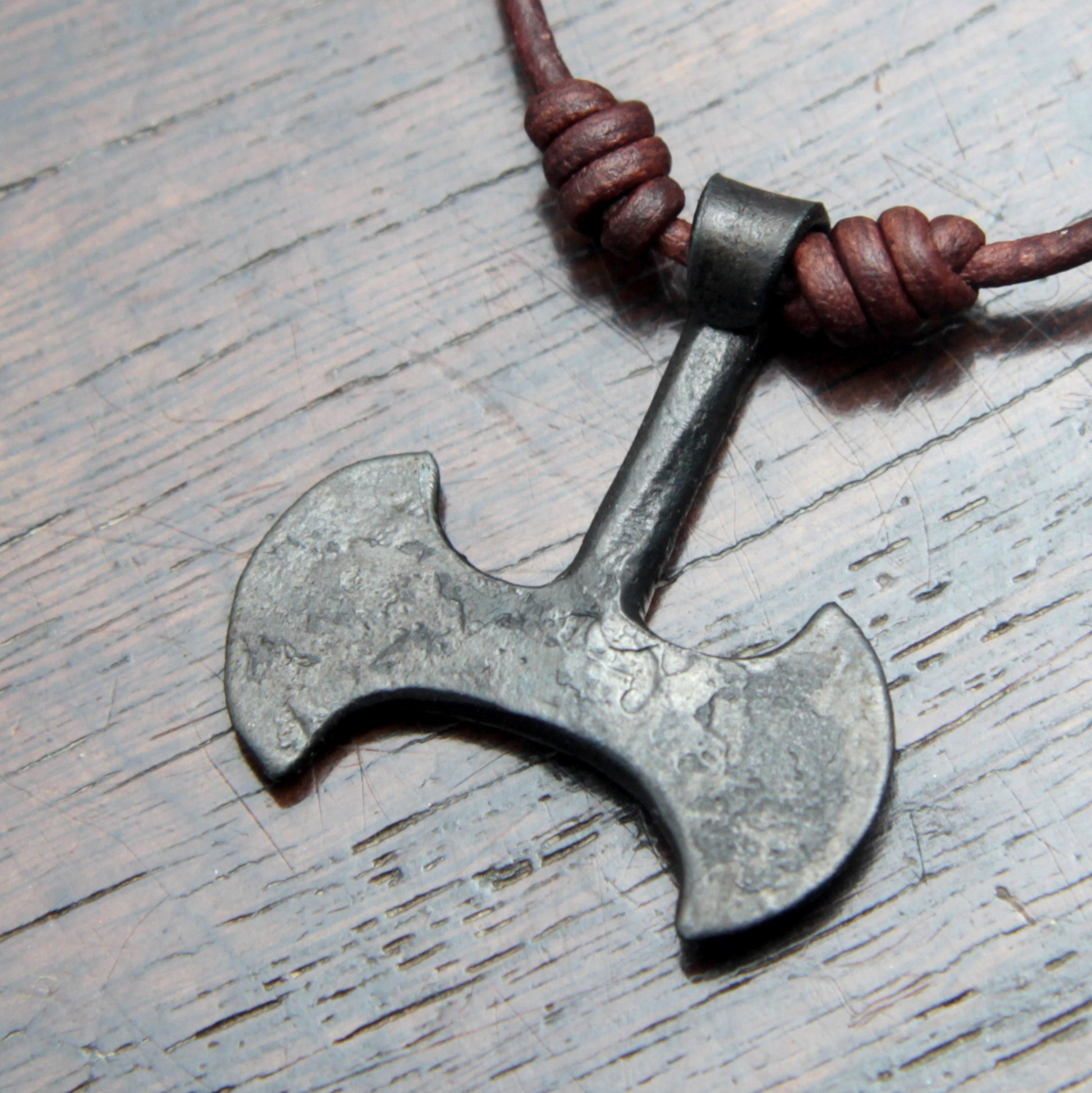 Picture of the back of the Taitaya Forge iron Labrys pendant.