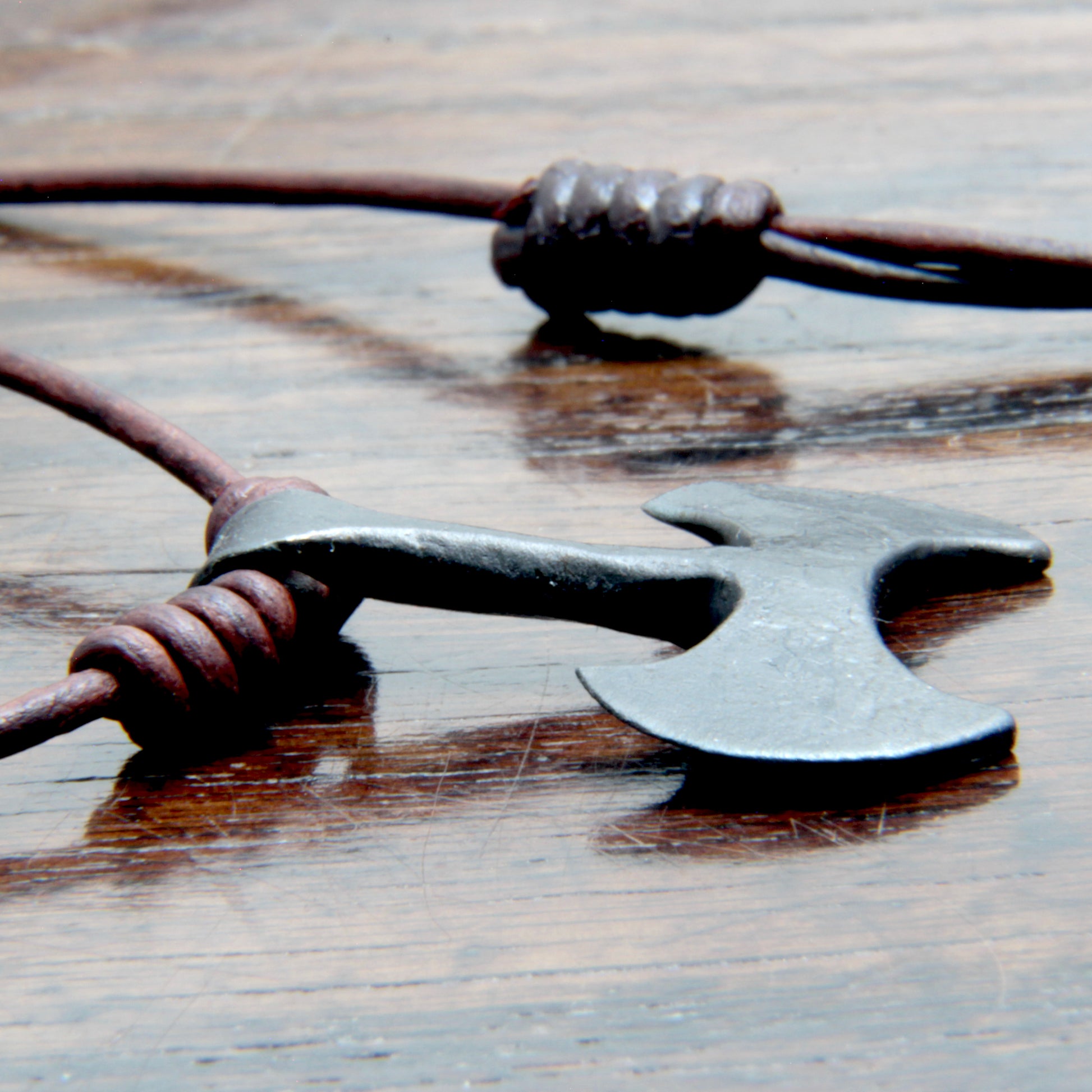 Side picture of the Taitaya Forge iron Labrys pendant.