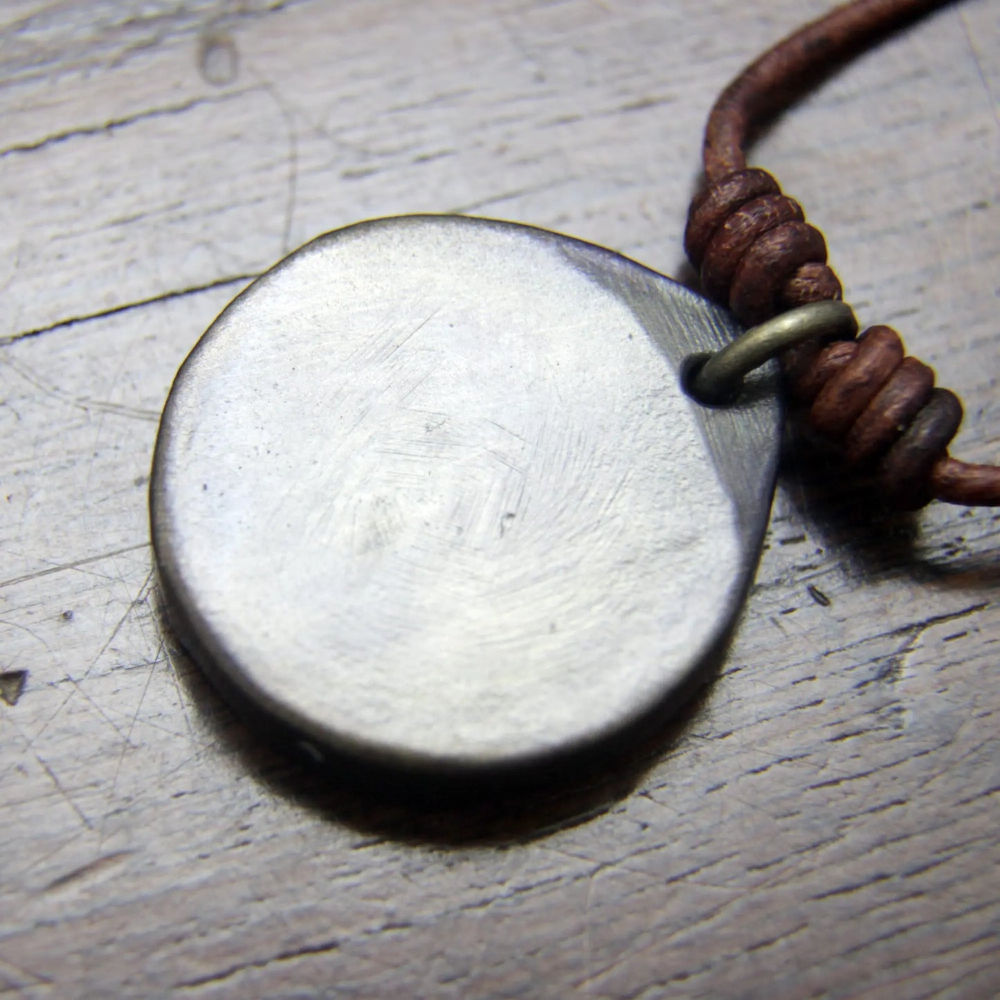 The blank back, or underside of theViking Raven Iron Coin Necklace. Norse Raven medallion pendant that can be personalised with silver inlay or a personal engraving.