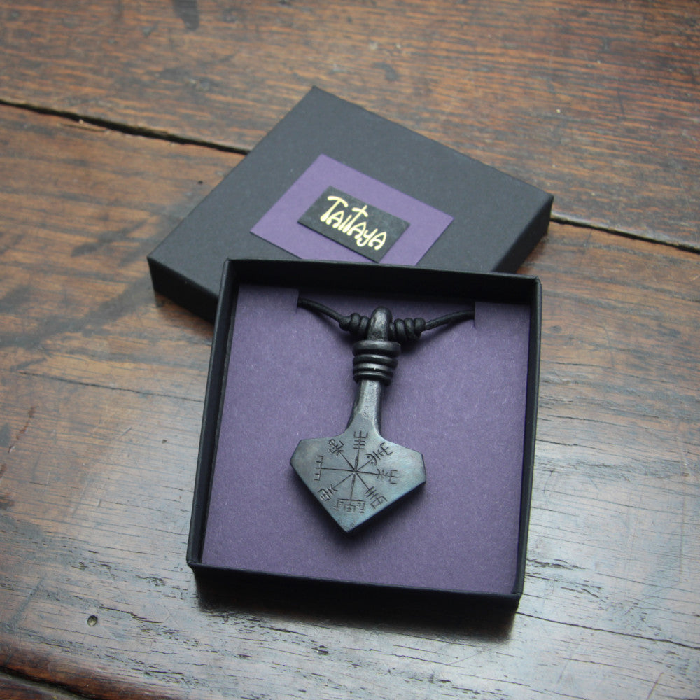 Handforged large Vegvisir engraved iron Mjolnir Thor's hammer pendant made by taitaya forge, presented in a black card gift box with gold embossed branding and purple insert card. 