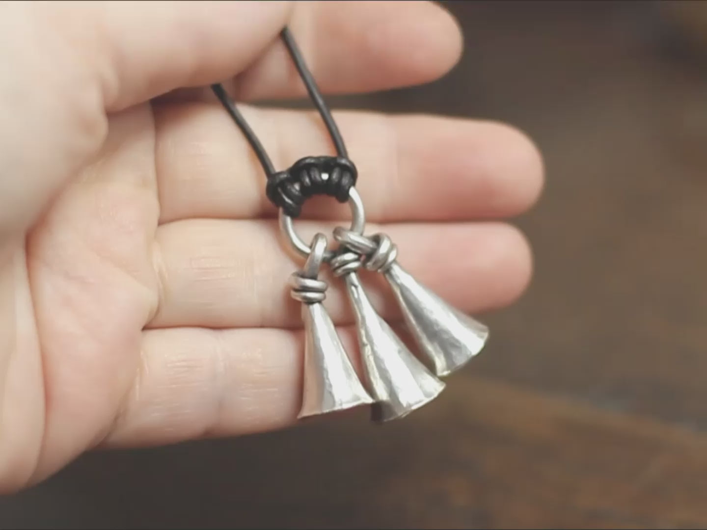 Hot Forged Sterling silver bell necklace by artist blacksmith Marleena Barran from Taitaya Forge