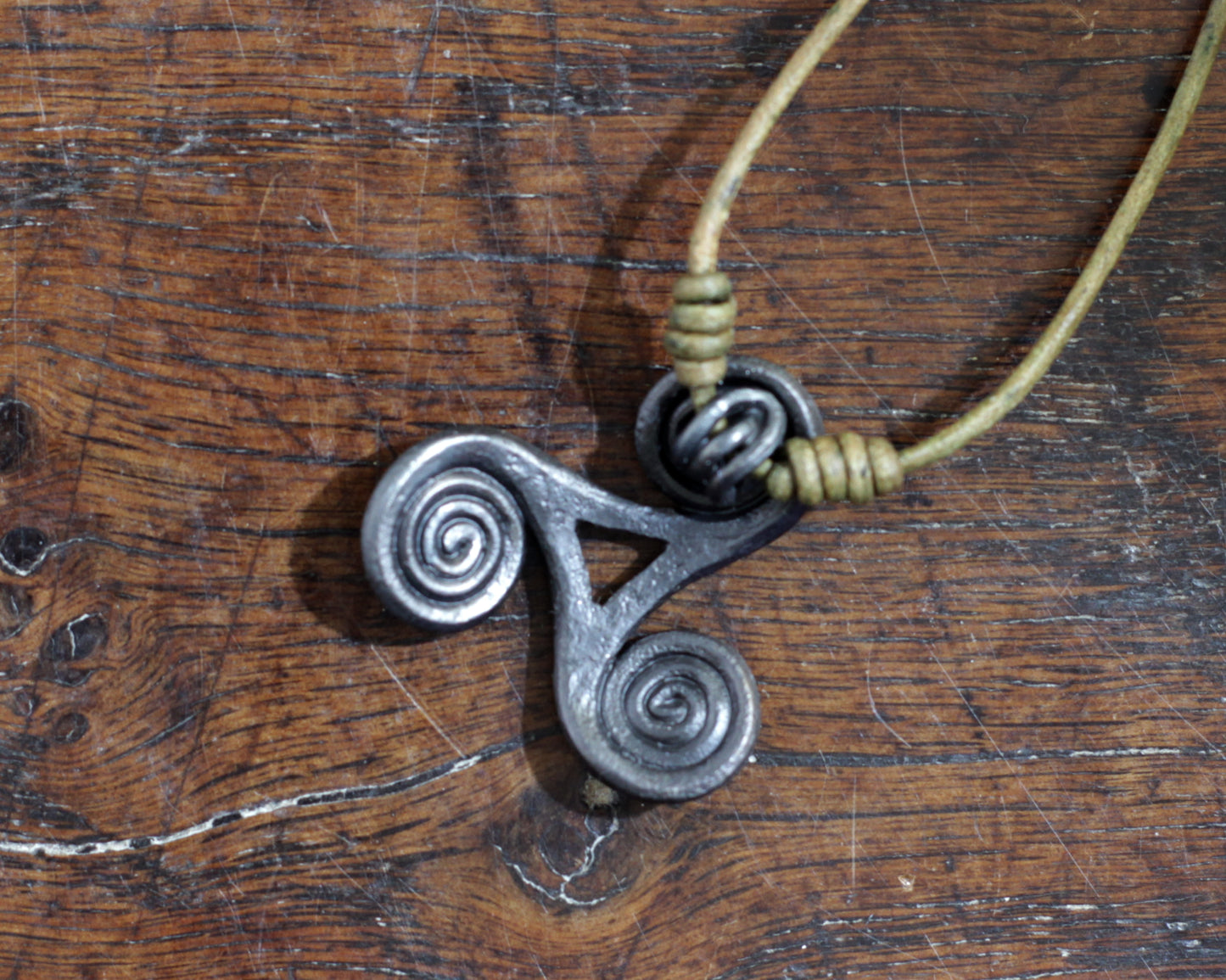 Hand Forged Iron Triskelion Necklace, designed and made by Blacksmith Marleena Barran from Taitaya Forge.  View from the back.
