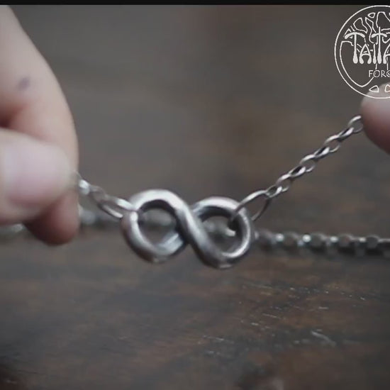 Hand forged solid silver infinity necklace, by blacksmith Marleena Barran at Taitaya Forge, UK