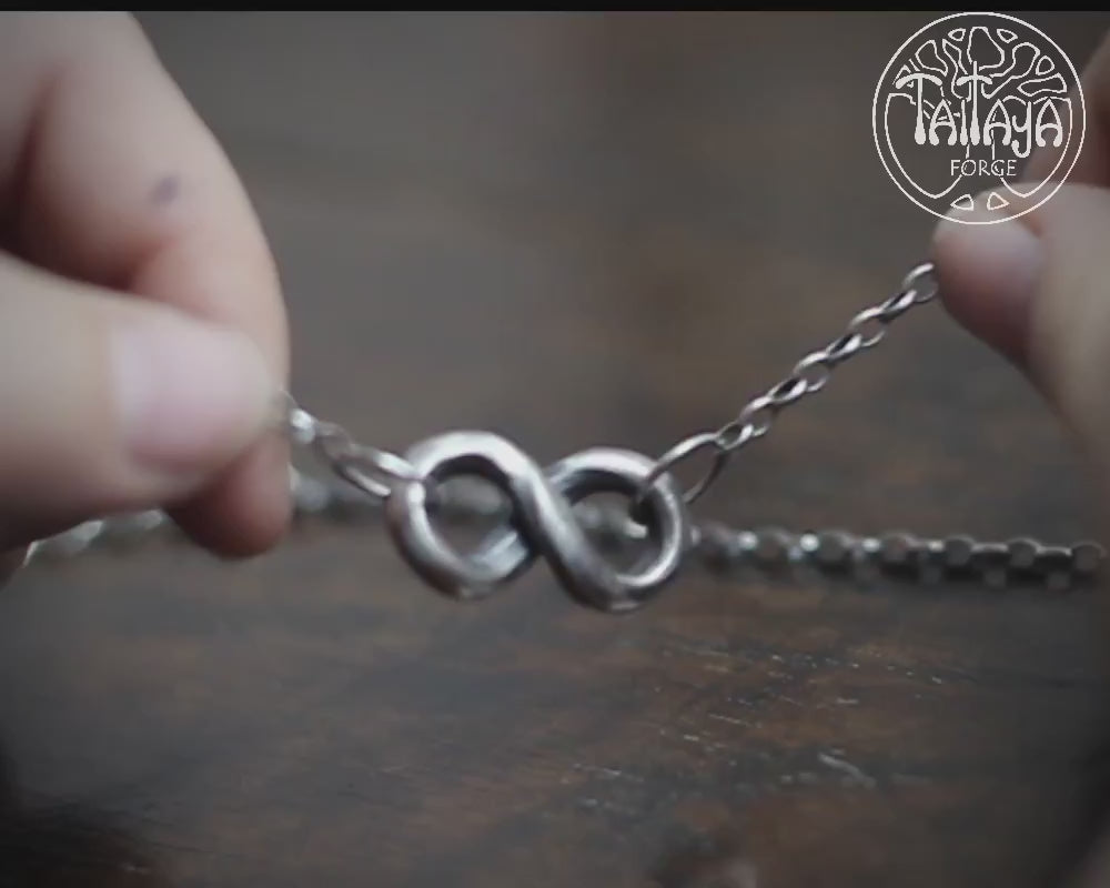 Hand forged solid silver infinity necklace, by blacksmith Marleena Barran at Taitaya Forge, UK