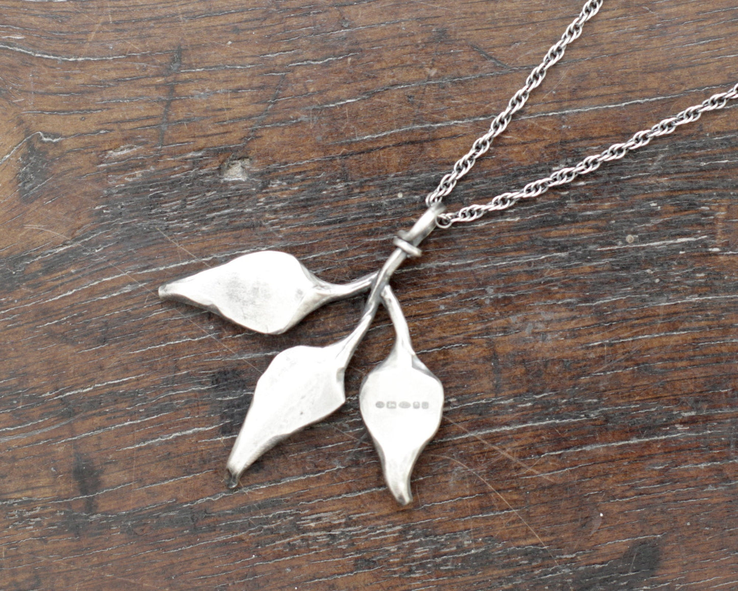 Triple leaf silver pendant. Unique hand forged solid silver necklace on a rope chain.