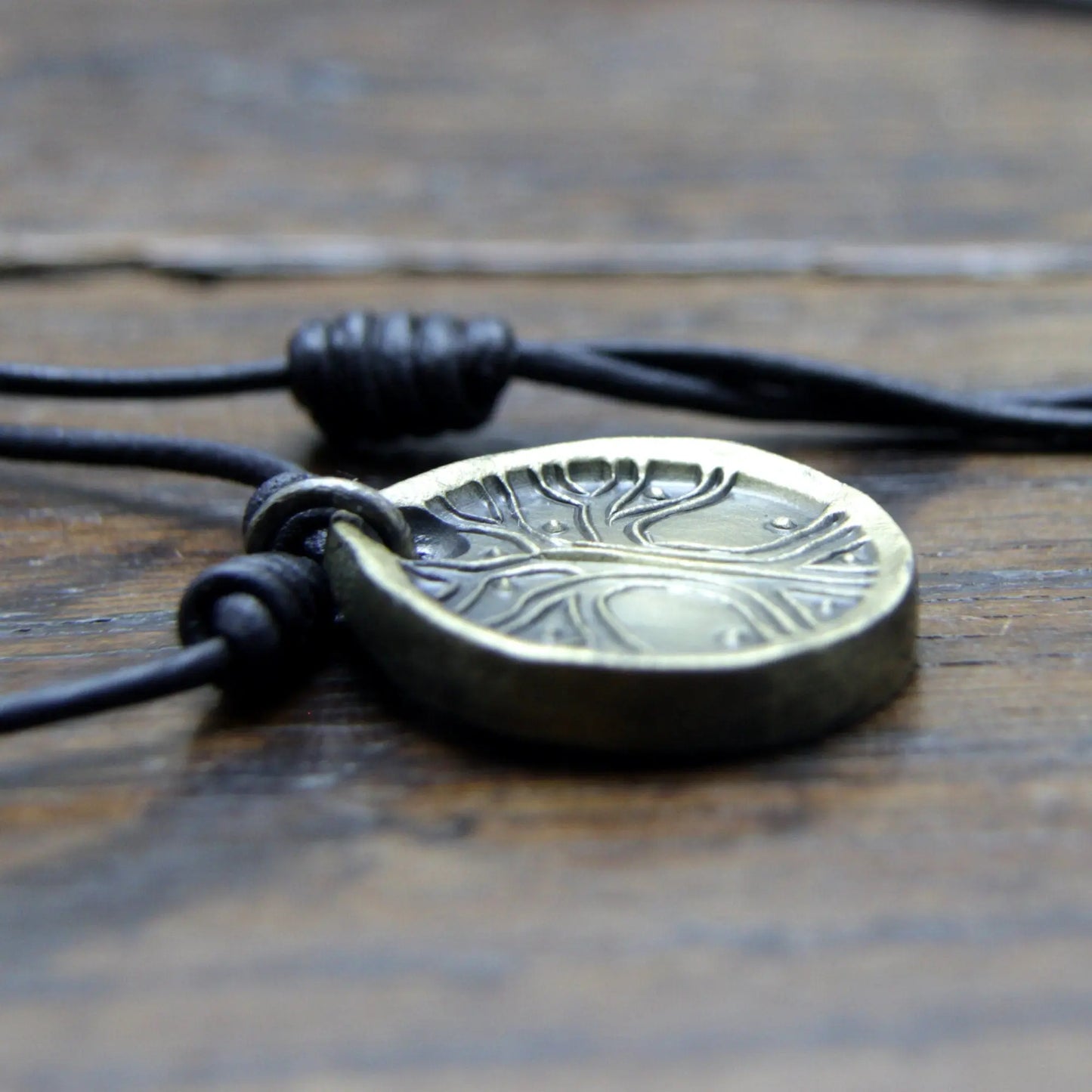 Norse Viking Yggdrasil Tree Iron Coin Pendant on a leather necklace.