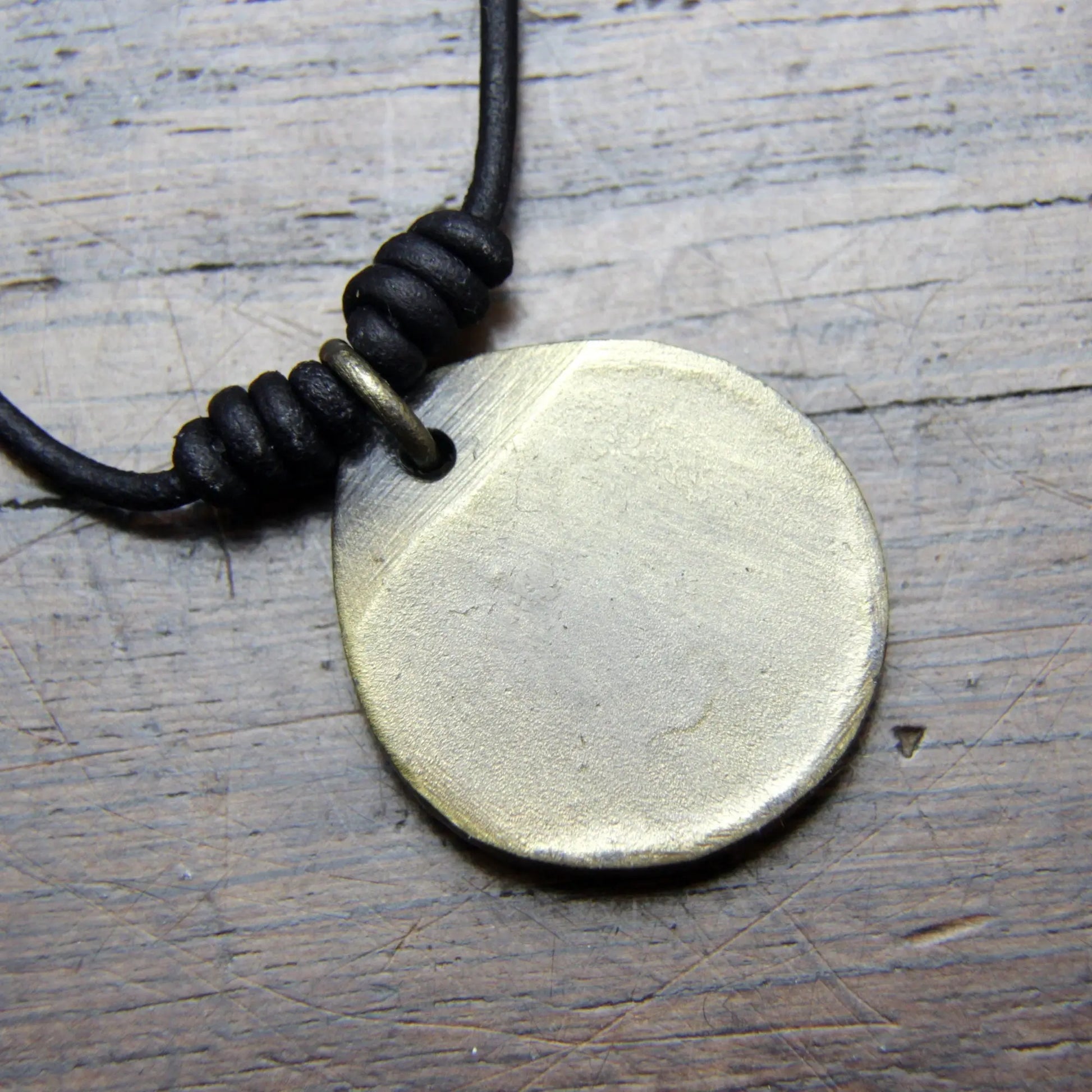 Norse Viking Yggdrasil Tree Iron Coin Pendant on a leather necklace.