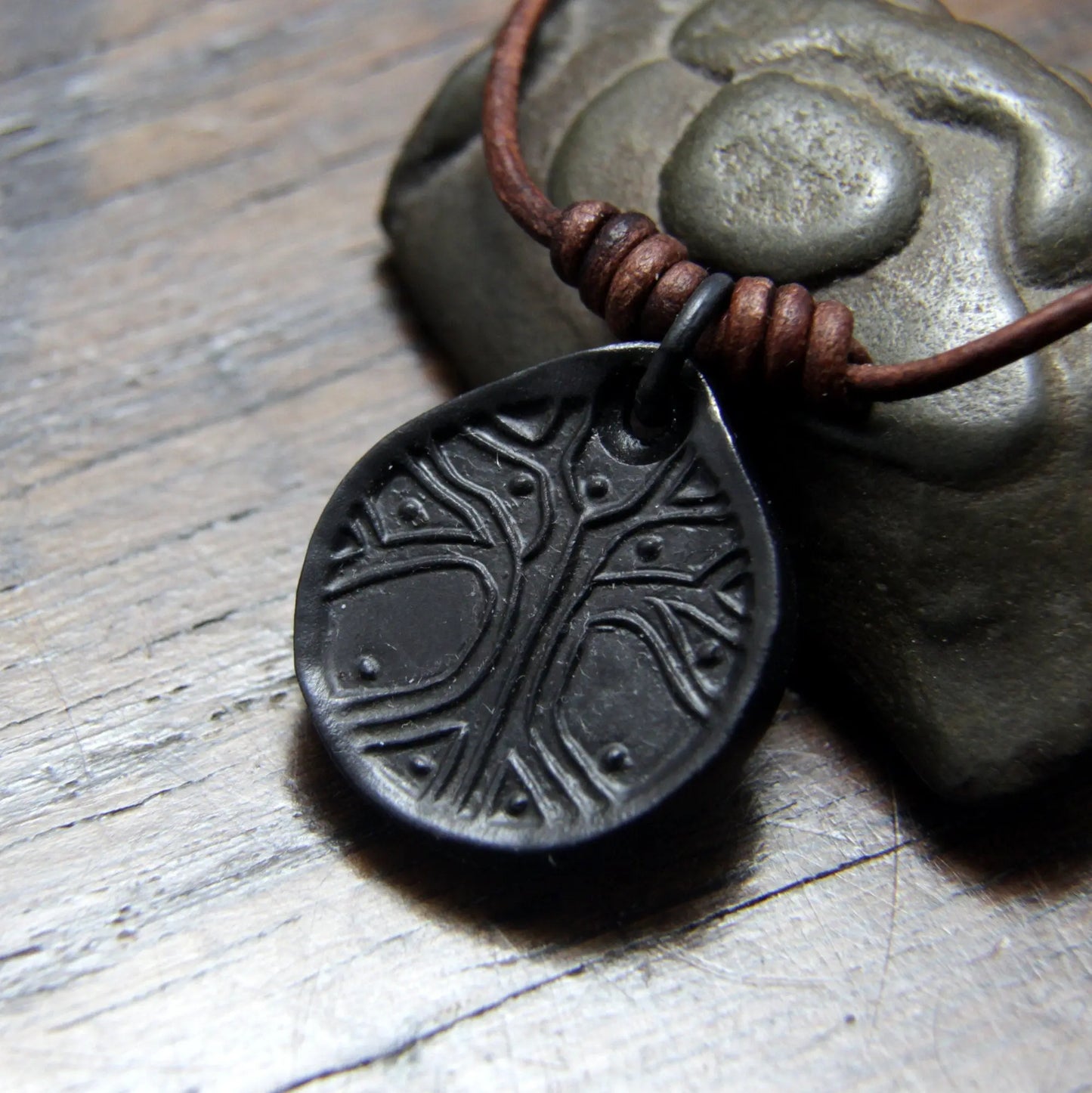 Norse Viking Yggdrasil Tree Iron Coin Pendant on a leather necklace.