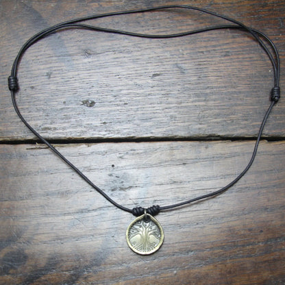Norse Viking Yggdrasil Tree Iron Coin Pendant on a leather necklace.